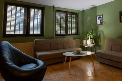 a living room with a couch and a table at City Centre Hostel in Niš