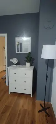 a room with a white dresser and a mirror at Central apartman3 Novi Sad in Bukorovac