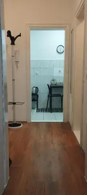 an empty room with a table and a glass door at Central apartman3 Novi Sad in Bukorovac