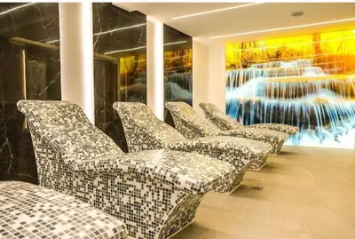 a row of chairs in a room with a painting at Kopaonik-President kop apartment 101 free wellness&spa in Kopaonik