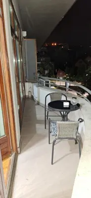 a balcony with two chairs and a table on a building at Apricus Mini Apartman Vrnjacka banja in Vrnjačka Banja