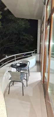 a patio with two chairs and a table on a balcony at Apricus Mini Apartman Vrnjacka banja in Vrnjačka Banja