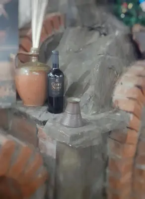 a figurine of a bottle of wine and a vase at Mića Alas vikendica in Orljane