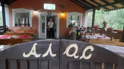 a man standing in the doorway of a restaurant at Mića Alas vikendica in Orljane