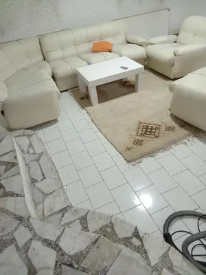 a living room with a couch and a coffee table at Mića Alas vikendica in Orljane