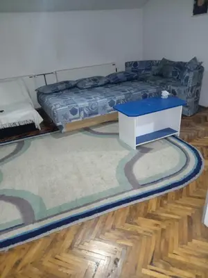 a bedroom with a bed and a blue table at Mića Alas vikendica in Orljane