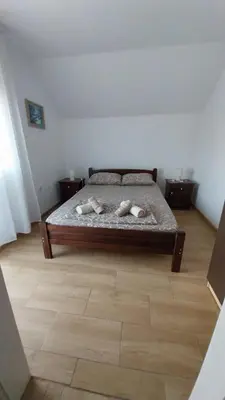 a bedroom with a bed with two towels on it at Orhideja smeštaj Sokobanja in Lepterija