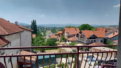 a view of a town from the balcony of a house at Orhideja smeštaj Sokobanja in Lepterija