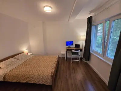 a bedroom with a bed and a desk with a computer at Studio Sanader in Soko Banja
