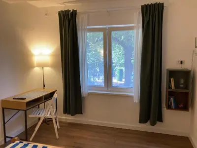 a room with a window with a desk and a table at Studio Sanader in Soko Banja