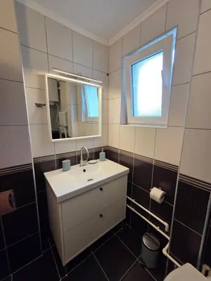 a bathroom with a sink and a mirror at Studio Sanader in Soko Banja