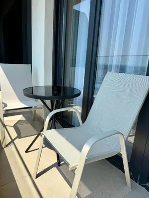 two chairs and a table on a balcony at Royal Apartmani 2 in Paraćin