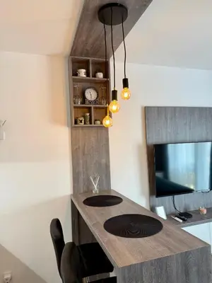 a kitchen with a counter with a sink and a tv at Royal Apartmani 2 in Paraćin