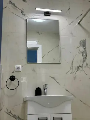 a bathroom with a sink and a mirror at Royal Apartmani 2 in Paraćin