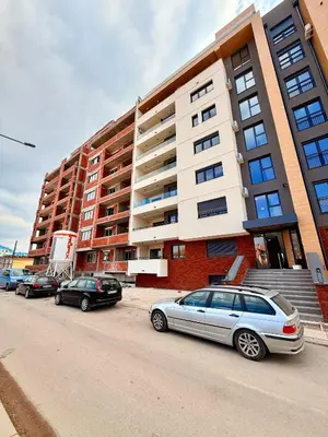 a row of cars parked in front of a building at Royal Apartmani 1 in Paraćin