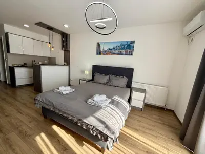 a bedroom with a bed with two towels on it at Royal Apartmani 1 in Paraćin