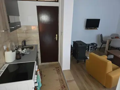 a kitchen with a sink and a door to a living room at Seosko domaćinstvo Trajković