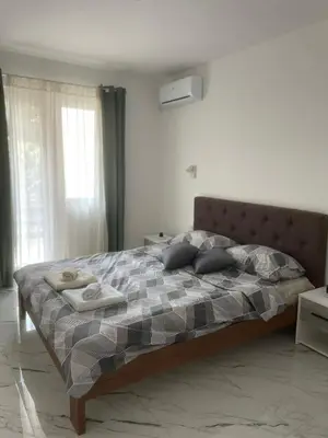 a bedroom with a large bed with a checkered blanket at Studio IV in Soko Banja