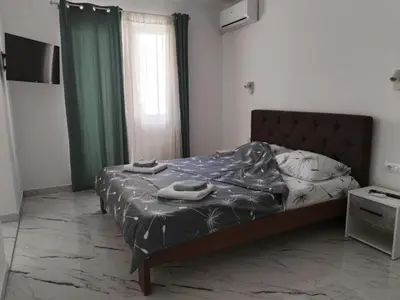 a bedroom with a bed with two towels on it at Studio IV in Soko Banja