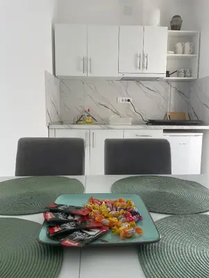 a plate of food on a table in a kitchen at Studio IV in Soko Banja