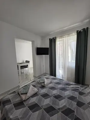 a bedroom with a black and white checkered floor at Studio IV in Soko Banja