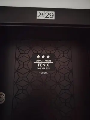 a sign on the front of a door at Apartman Fenix in Pirot