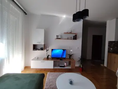 a living room with a couch and a tv at Apartman Fenix in Pirot