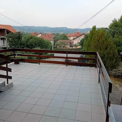 a balcony with a wooden railing and a view at Apartmani Sokobanja Alexandar in Soko Banja
