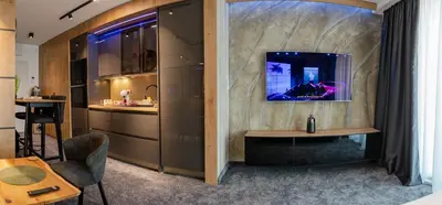a living room with a tv on a wall at Grey Nest - Luxury Studio Apartment in Planet Residence, Niš in Niš