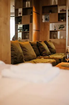 a living room with a couch with pillows at Grey Nest - Luxury Studio Apartment in Planet Residence, Niš in Niš