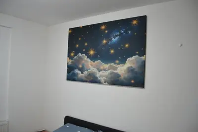 a painting of a starry sky on a wall at Star Apartman in Vranje
