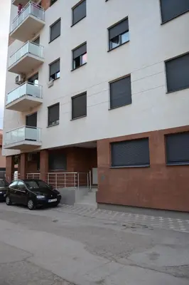 a black car parked in front of a building at Star Apartman in Vranje