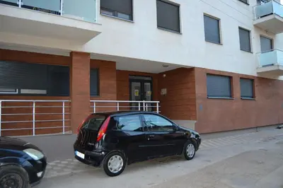 a small black car parked in front of a building at Star Apartman in Vranje