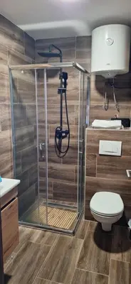 a bathroom with a shower and a toilet at Sweet dreams apartman in Kopaonik
