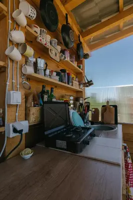 a kitchen with a sink and a tv on a wall at Sve Mir in Boljevac