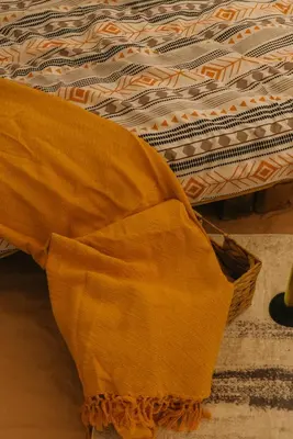 a close up of a bed with a blanket on it at Sve Mir in Boljevac