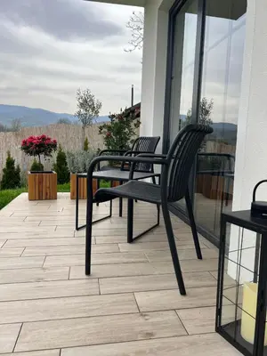 two chairs and a table on a patio at LaLuna Houses in Lipova