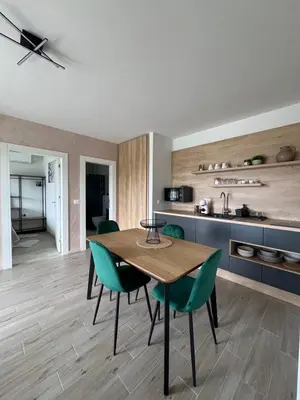 a kitchen and dining room with a table and chairs at LaLuna Houses in Lipova