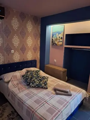 a bedroom with a bed with a blanket and pillows at Dolce Vita in Bukorovac