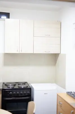 a kitchen with white cabinets and a stove top oven at Dolce Vita in Bukorovac