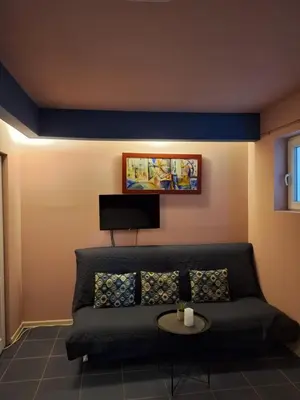a living room with a couch and a tv at Dolce Vita in Bukorovac