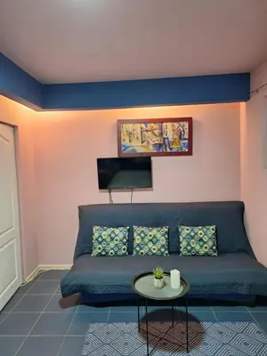a living room with a blue couch and a table at Dolce Vita in Bukorovac