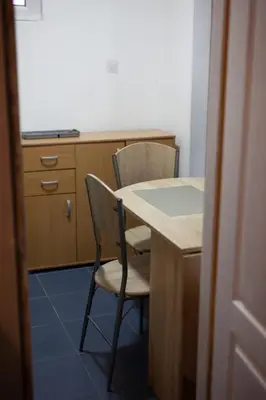 a kitchen with a table and two chairs and a desk at Dolce Vita in Bukorovac