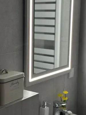 a bathroom with a mirror and a sink and a sink at Palas Central Delux & SPA in Niš