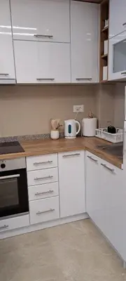 a white kitchen with white cabinets and appliances at Apartman Kristal, Vrnjačka Banja in Vrnjci