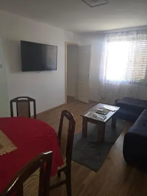 a living room with a table and a couch at Yellow hill Batinac in Ćuprija