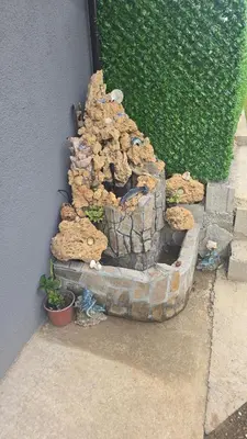 a small rock garden on the side of a building at Yellow hill Batinac in Ćuprija