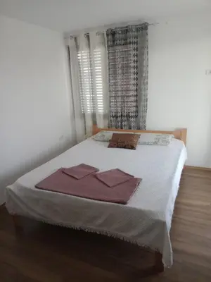 a bedroom with a bed with two towels on it at Yellow hill Batinac in Ćuprija