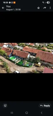 a screenshot of a video of a house with roofs at Yellow hill Batinac in Ćuprija