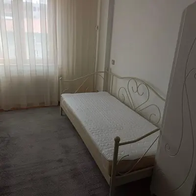 a small bed in a room with a window at Zora in Niš